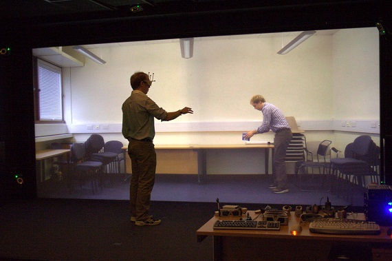 human wearing 3d glasses in front of large screen